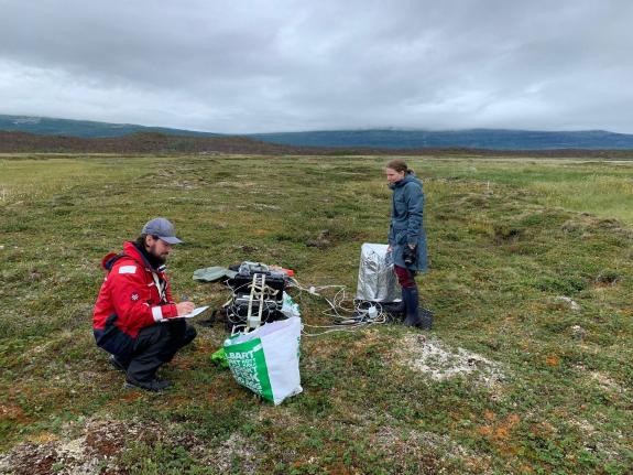 Two researchers with their instruments in the Canadiean Arctic.